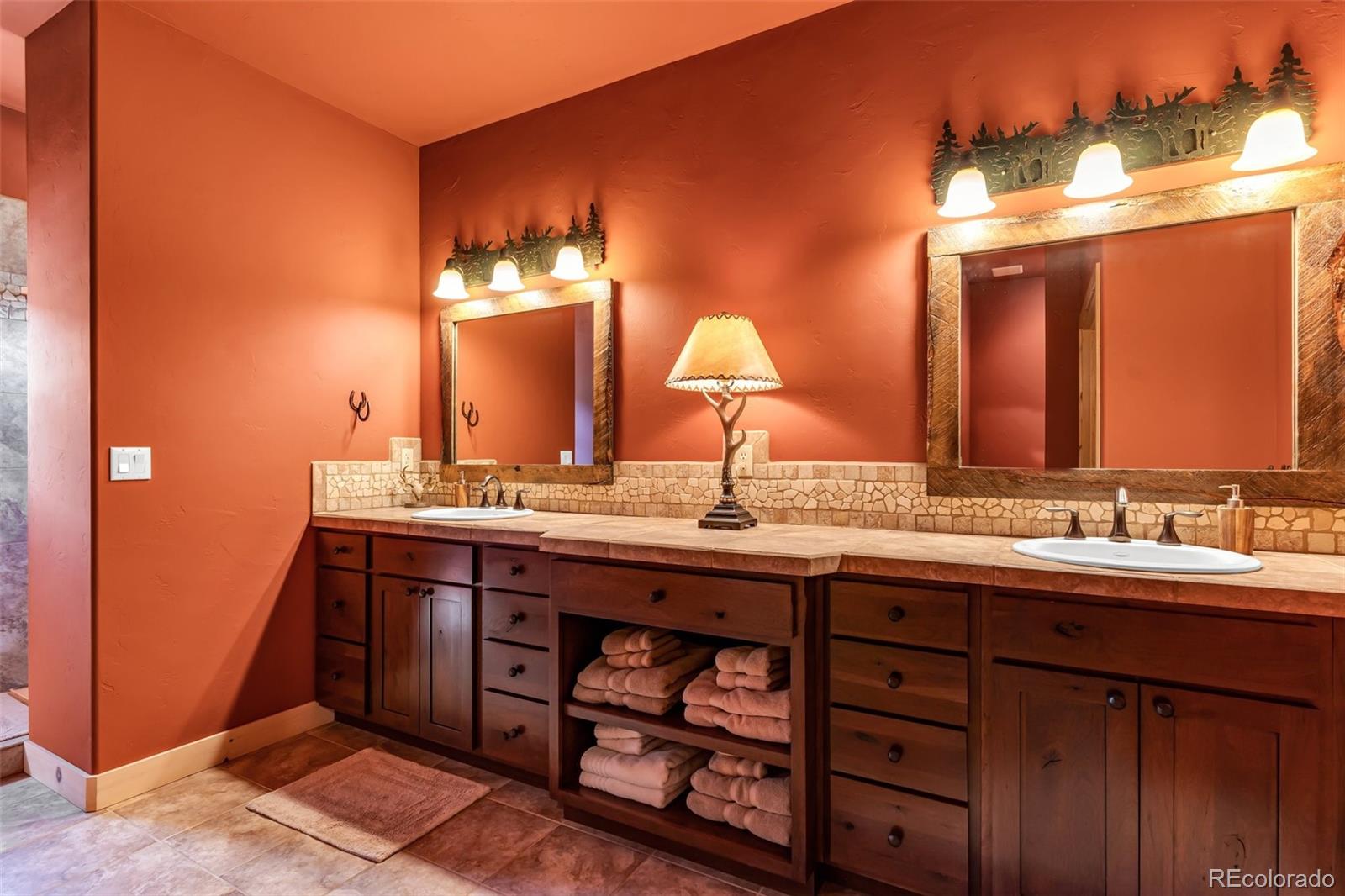 400 Ridge Road Westcliffe, CO 81252 - Photo 14 of 37 a bathroom with a double vanity sink and a mirror