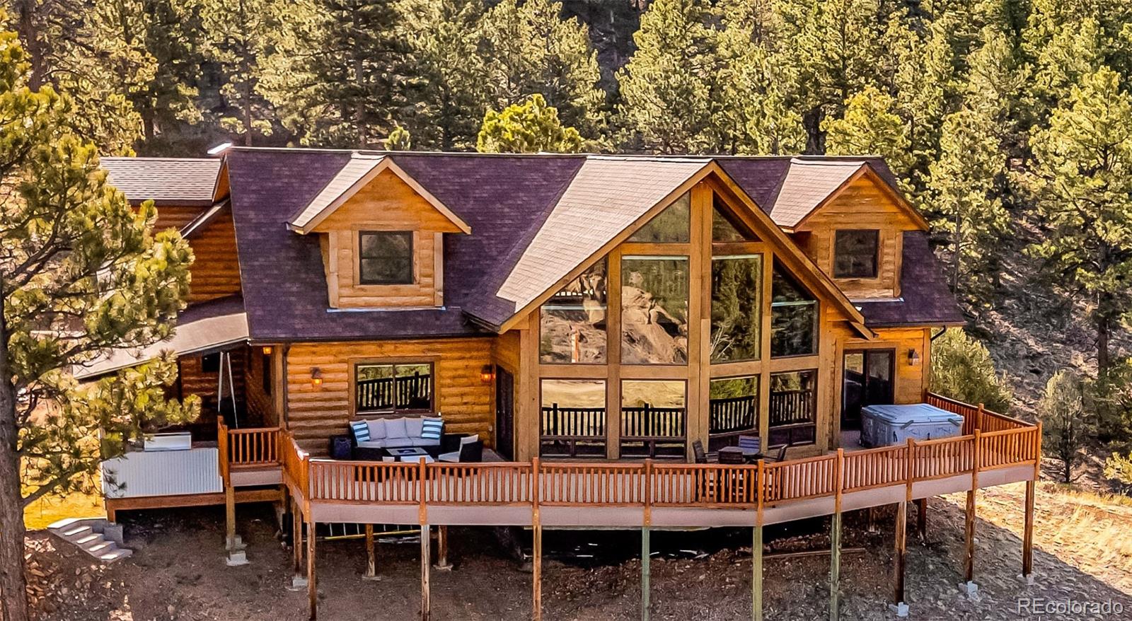 400 Ridge Road Westcliffe, CO 81252 - Photo 2 of 37 a view of a house with wooden deck and furniture