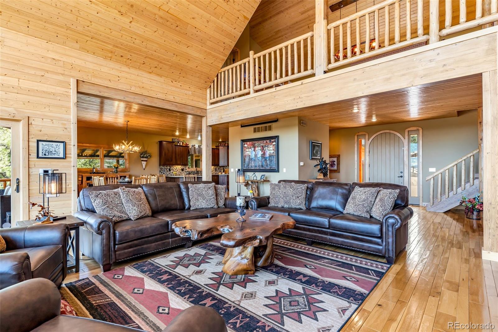 400 Ridge Road Westcliffe, CO 81252 - Photo 5 of 37 a living room with furniture a rug and a floor to ceiling window