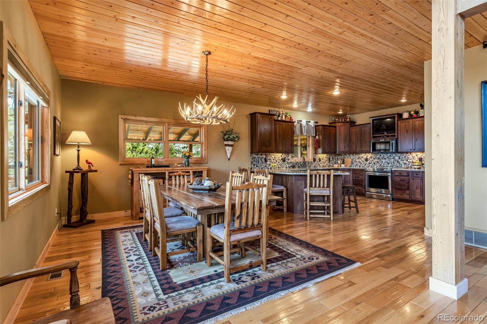 400 Ridge Road Westcliffe, CO 81252 - Photo 7 of 37 a dining room with lots of wooden furniture
