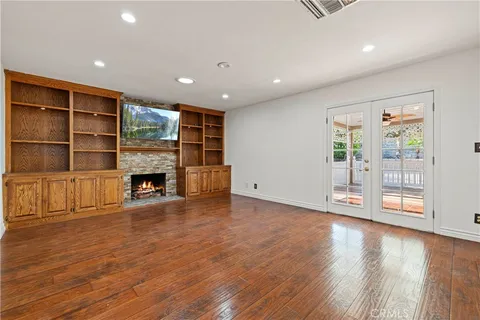 a view of an empty room with a fireplace and a window
