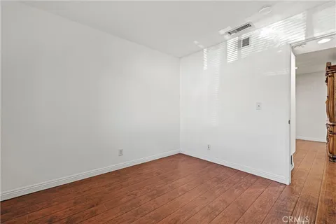 a bathroom with a granite countertop toilet a sink a mirror and a shower