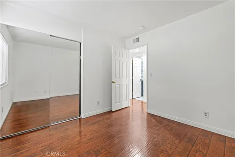a view of room with wooden floor and window