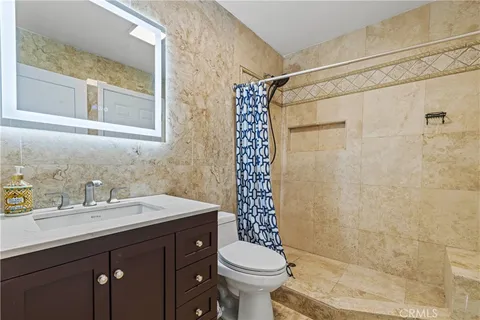 a view of house with backyard and sitting area