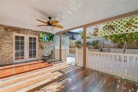 a view of a porch with a table and chairs a barbeque with wooden fence