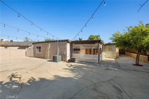 a view of a yard with potted plants