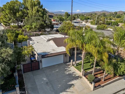 an aerial view of a house with a yard