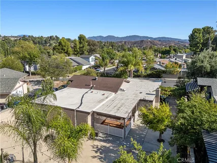 a aerial view of a house with a yard and garden in front of it