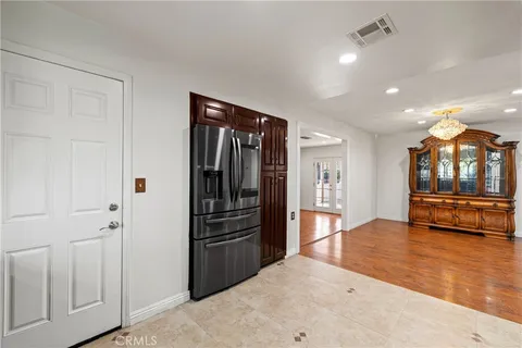 a large kitchen with a large counter top kitchen island stainless steel appliances and cabinets