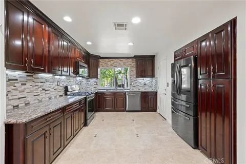 a view of a livingroom with wooden floor and a fireplace