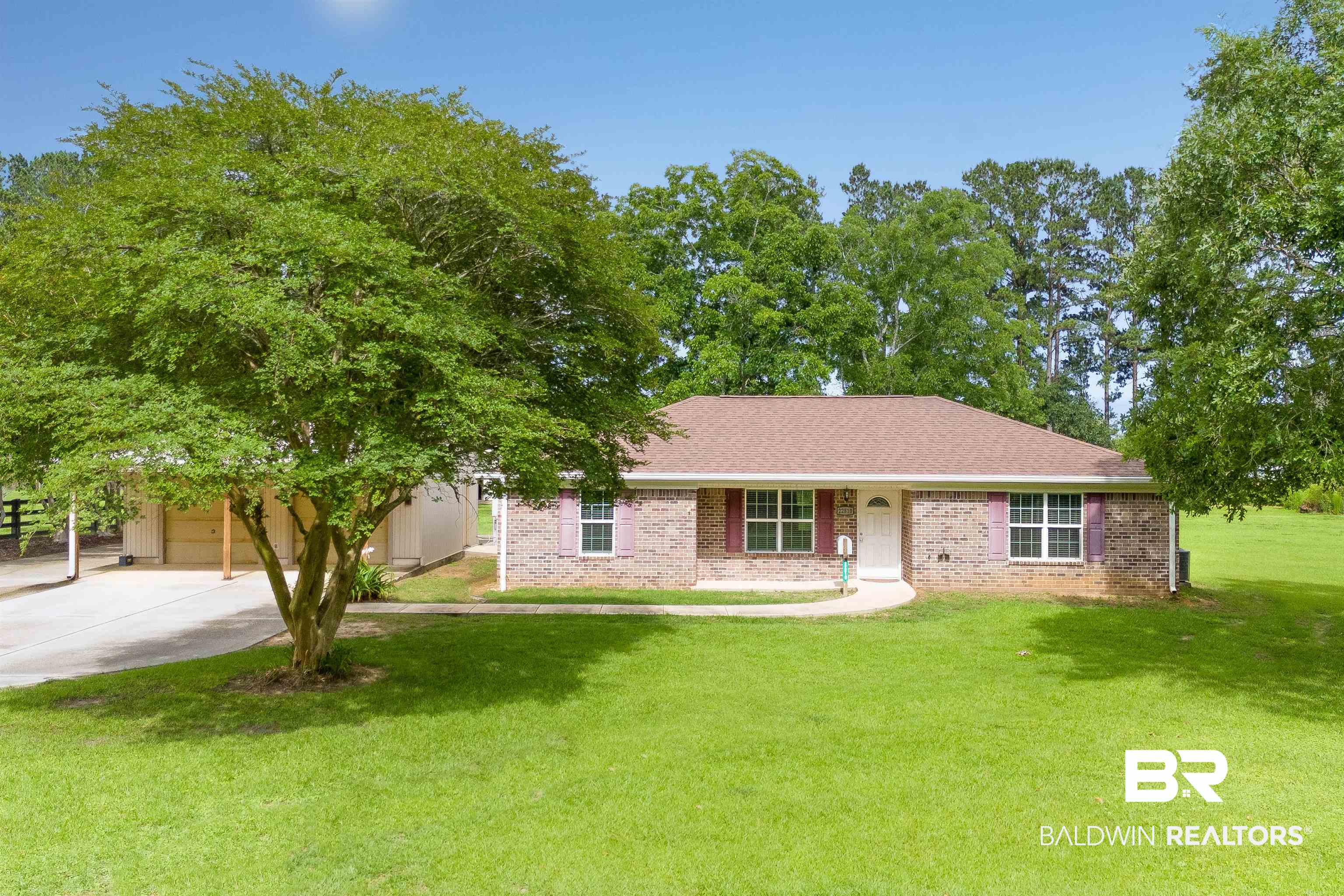 22810 Ard Road Robertsdale, AL 36567 - Photo 7 of 65 View of front facade featuring brick siding, a garage, concrete driveway, and a front lawn