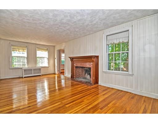 58 Ravine Road Medford, MA 02155 - Photo 6 of 13 a view of empty room with wooden floor and fireplace