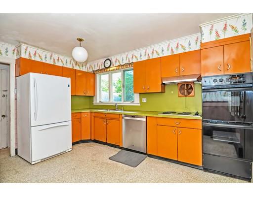 58 Ravine Road Medford, MA 02155 - Photo 7 of 13 a kitchen with granite countertop stainless steel appliances and wooden cabinets