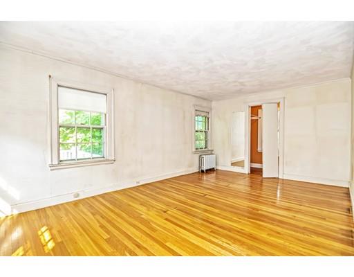 58 Ravine Road Medford, MA 02155 - Photo 10 of 13 a view of an empty room with wooden floor and a window