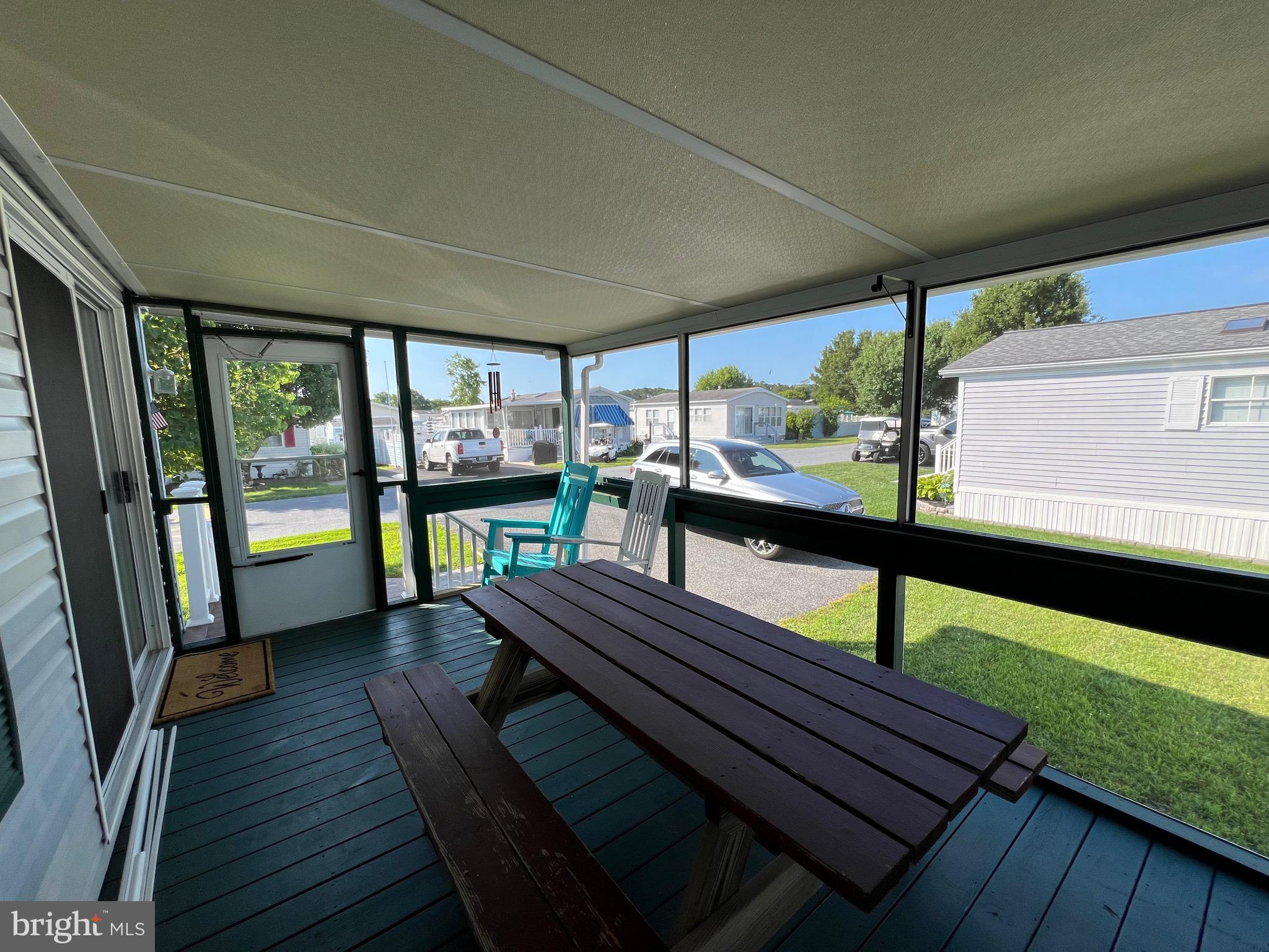 12407 Pegleg Way Berlin, MD 21811 - Photo 2 of 86 a view of a balcony with chairs and wooden floor