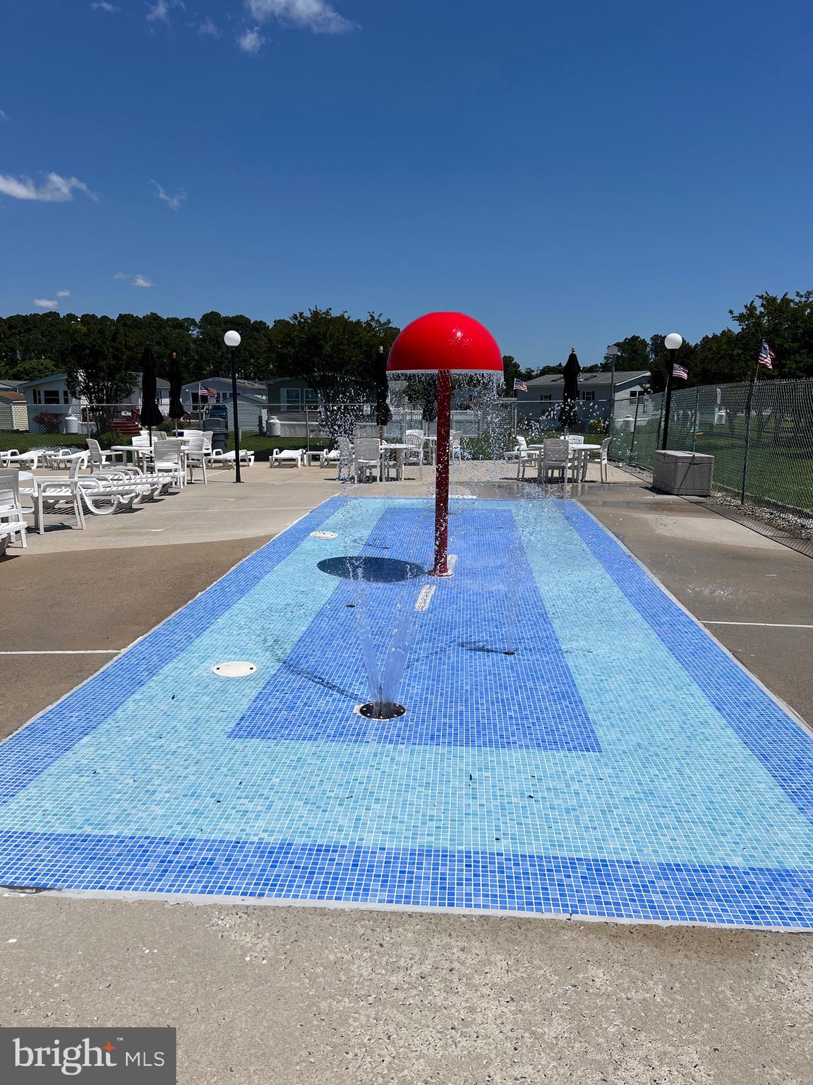 12407 Pegleg Way Berlin, MD 21811 - Photo 22 of 86 a view of swimming pool with a table and chairs