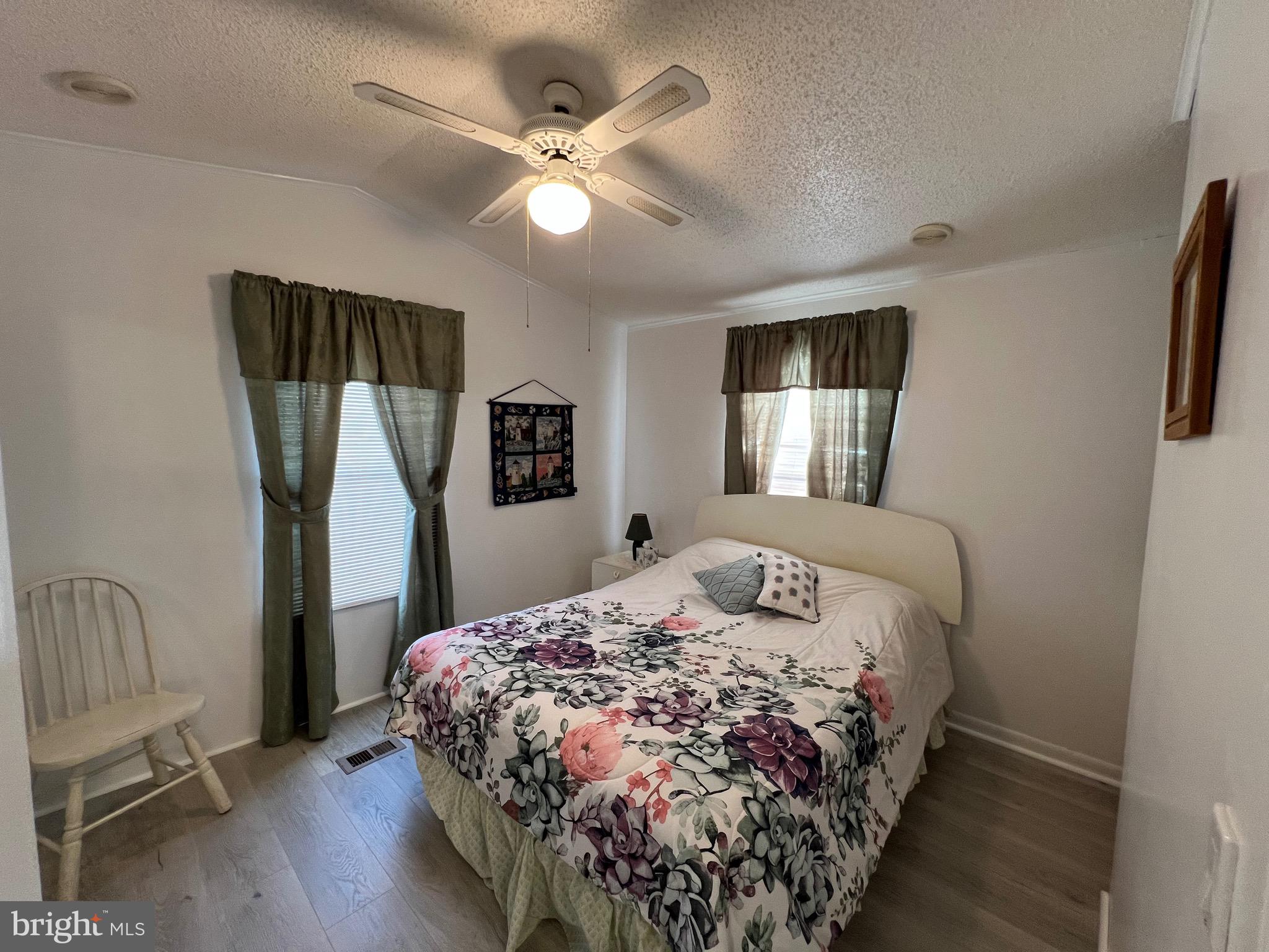 12407 Pegleg Way Berlin, MD 21811 - Photo 8 of 86 a bedroom with a large bed and a chandelier