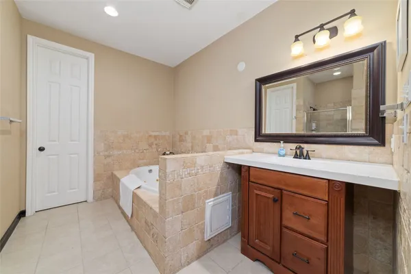 a spacious bathroom with a double vanity sink and a mirror