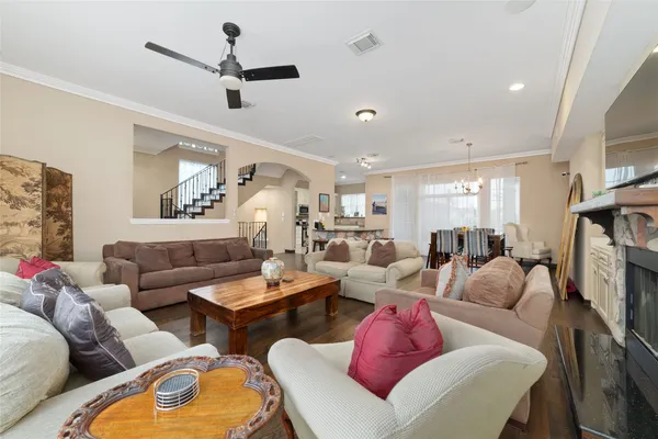 a living room with furniture a ceiling fan and a fireplace