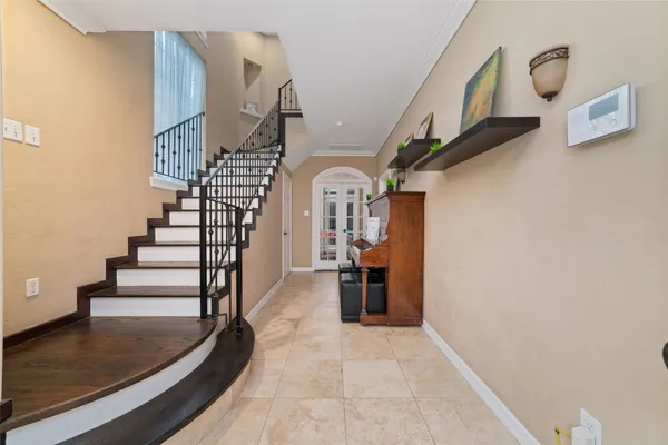 a view of entryway and hall with wooden floor