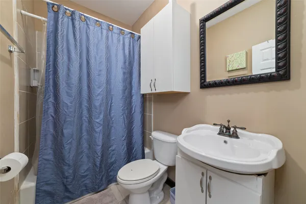 a bathroom with a sink toilet and mirror