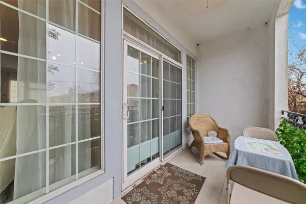 a view of a room with furniture and windows