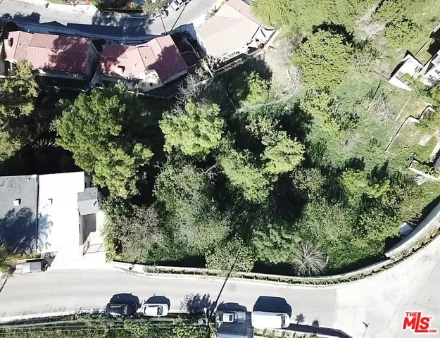 an aerial view of a house with a yard