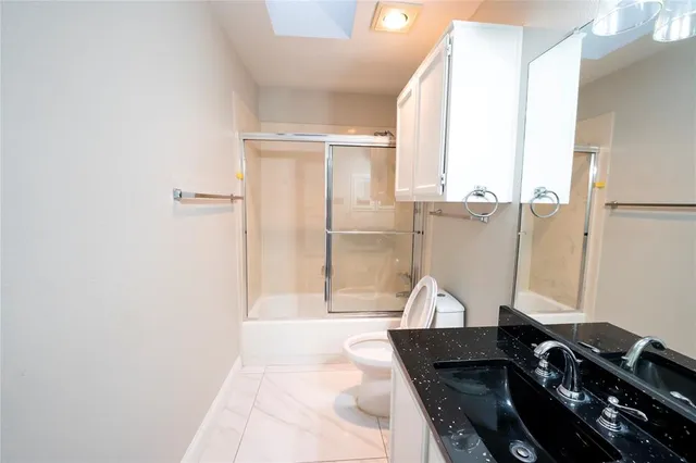 a hallway with a large window and sitting area