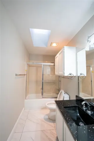 a kitchen with granite countertop a sink and a stove
