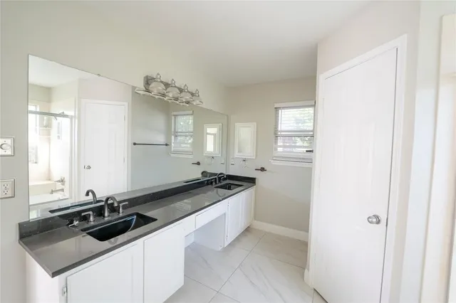 a kitchen with a sink and cabinets