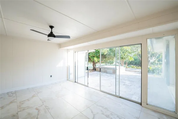 a view of a livingroom with a ceiling fan and window