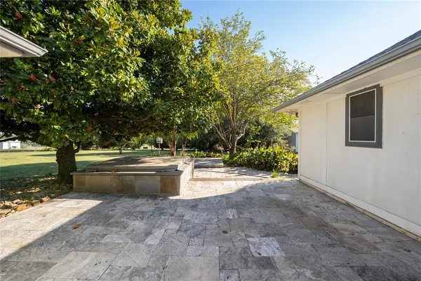 a view of backyard with tub and trees around