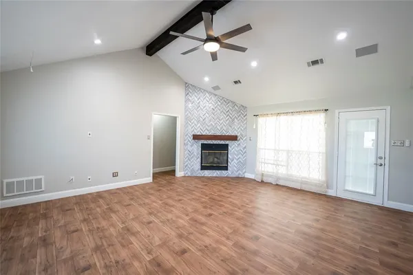 an empty room with fan and windows