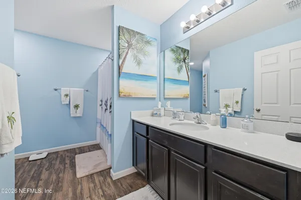 a bathroom with a sink double vanity granite and a mirror