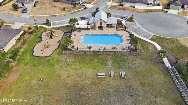an aerial view of a house with a swimming pool