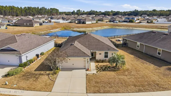 an aerial view of a house with a yard swimming pool and outdoor seating
