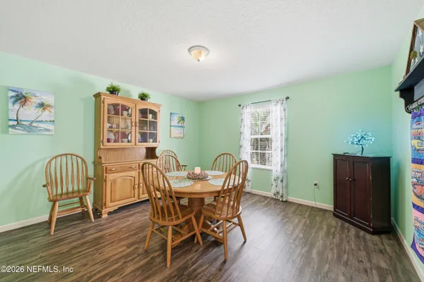 a view of a dining room with furniture and wooden floor