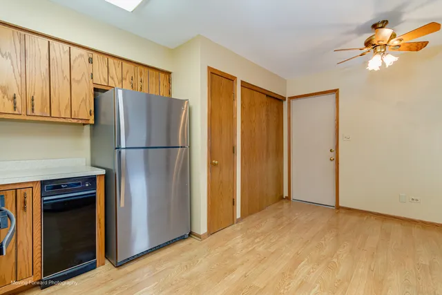 a view of kitchen with stainless steel appliances granite countertop cabinets and a refrigerator