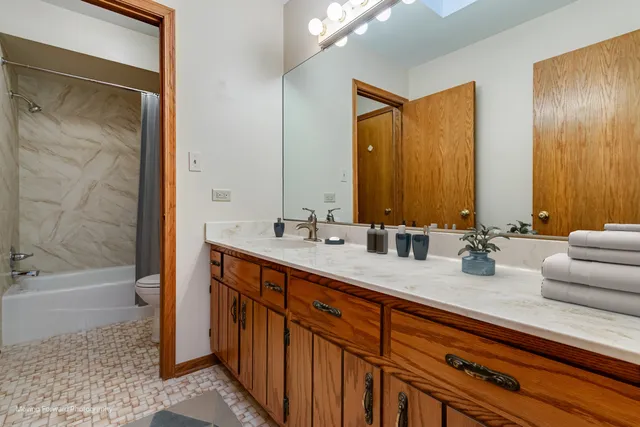 a bathroom with 2 sink tub and a mirror