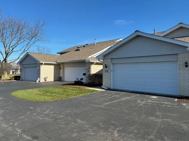 a view of a house with a yard and garage