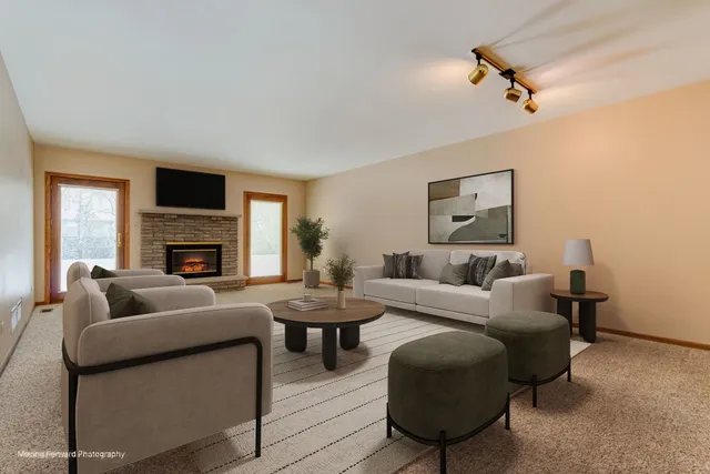a living room with furniture a fireplace and a flat screen tv