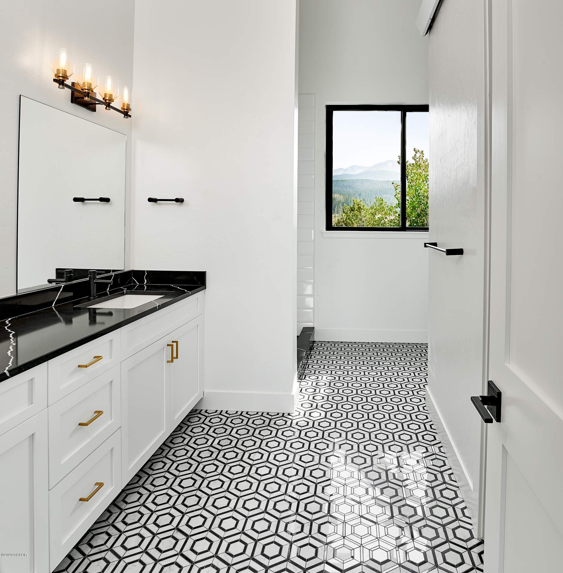 108 Rendezvous Way Winter Park, CO 80482 - Photo 11 of 16 a bathroom with a sink and a mirror