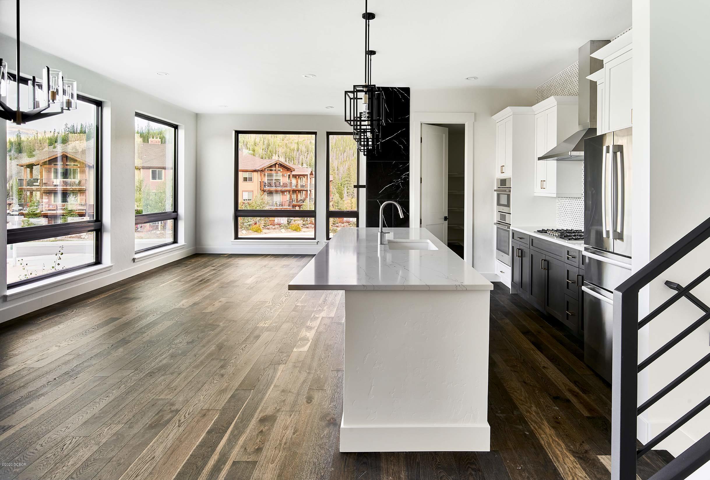 108 Rendezvous Way Winter Park, CO 80482 - Photo 7 of 16 a kitchen with stainless steel appliances granite countertop a refrigerator a stove and a wooden floors