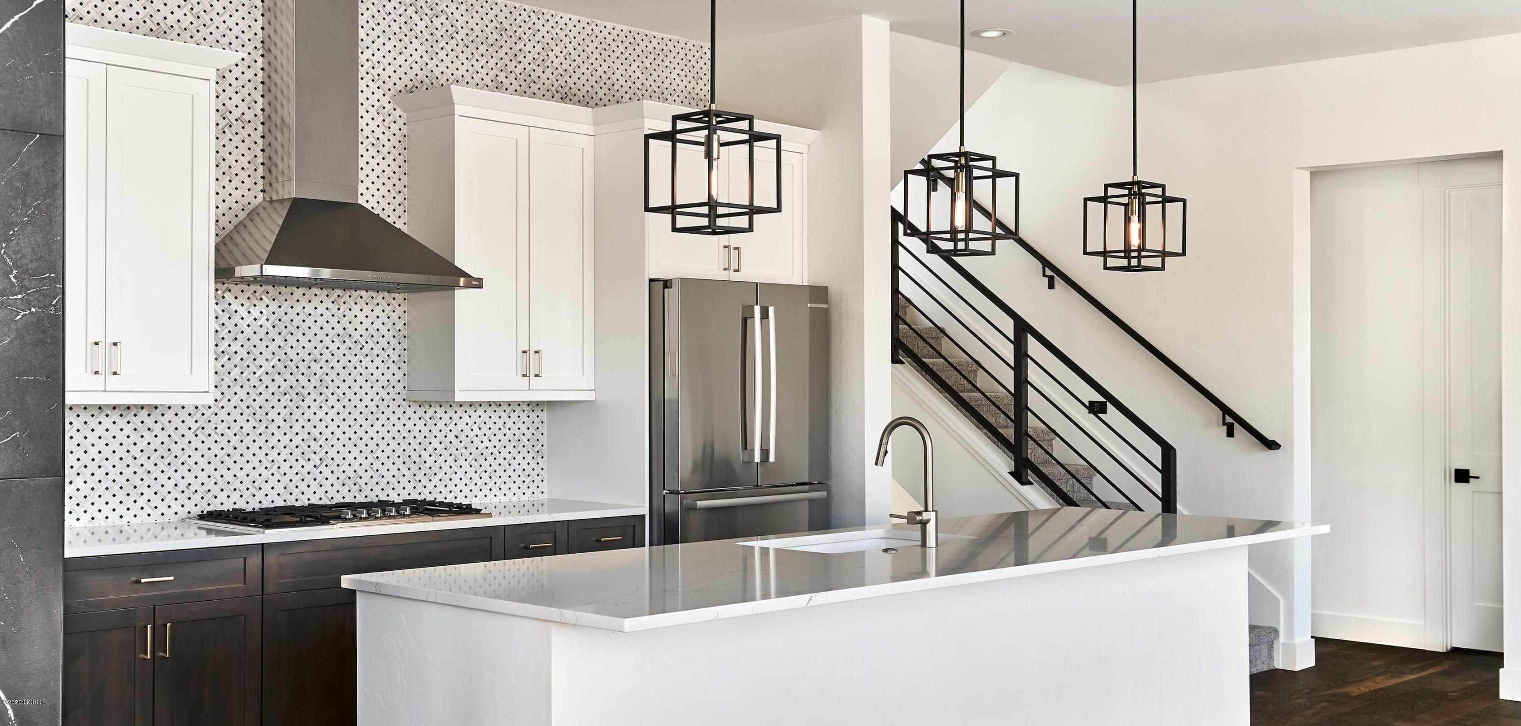 108 Rendezvous Way Winter Park, CO 80482 - Photo 9 of 16 a kitchen with stainless steel appliances granite countertop a sink and a refrigerator