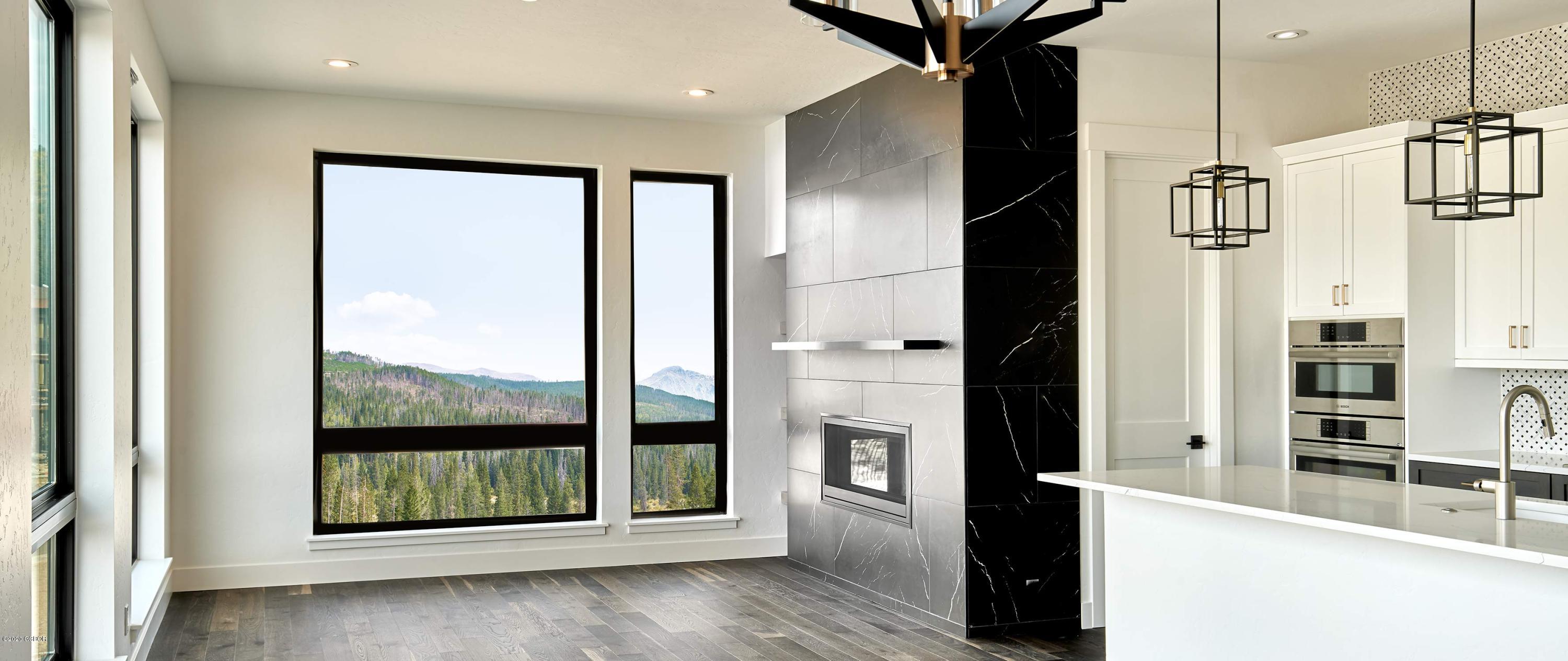 108 Rendezvous Way Winter Park, CO 80482 - Photo 10 of 16 a view of a hallway with wooden floor and a kitchen