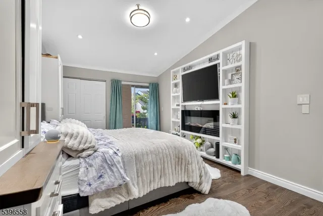 a bedroom with a bed and a flat tv screen