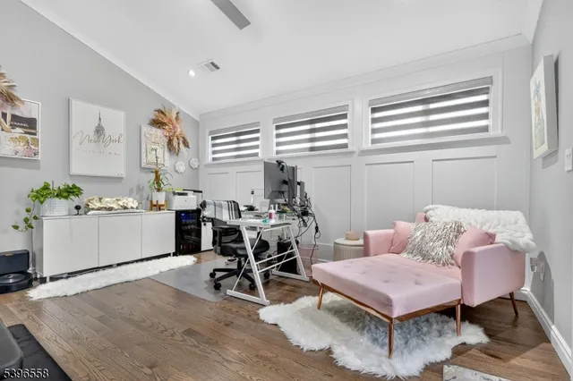 a living room with furniture a dining table and a window