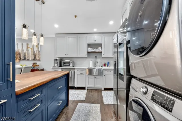 a kitchen with a sink a stove and cabinets