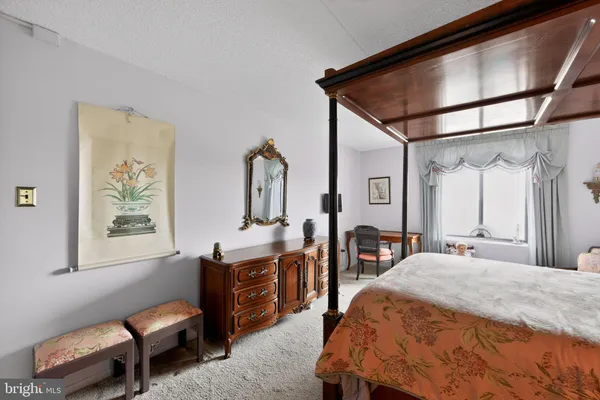 a bedroom with bed and a window