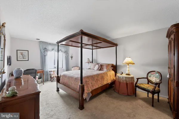 a bedroom with a bed a desk and chair